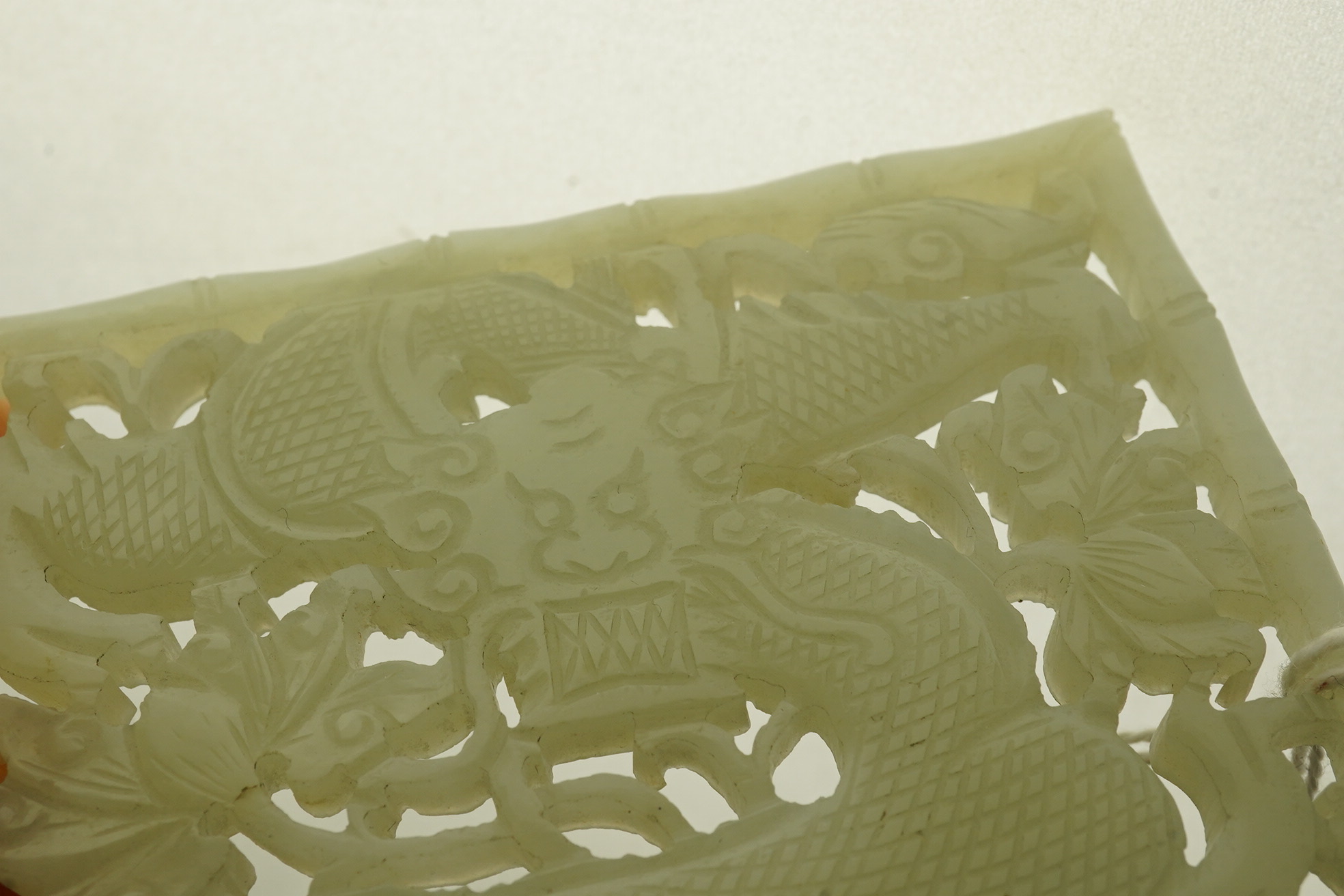 A Chinese pale celadon jade reticulated ‘dragon’ plaque, 19th century